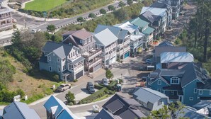 A residential area with houses featuring gabled roofs and multiple stories. - Ocean-View Home- Chefs Kitchen,  Private Hot Tub, Dog Friendly, Double Patio (Pacific Beach)