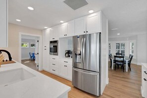 Fridge, microwave, oven, stovetop - Ocean Sunrise – Bayfront Luxury with Pool, Dock & Game Room. Steps to Gulf. Perfect for Families. (Bradenton Beach)