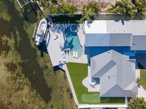 Exterior - Ocean Sunrise – Bayfront Luxury with Pool, Dock & Game Room. Steps to Gulf. Perfect for Families. (Bradenton Beach)