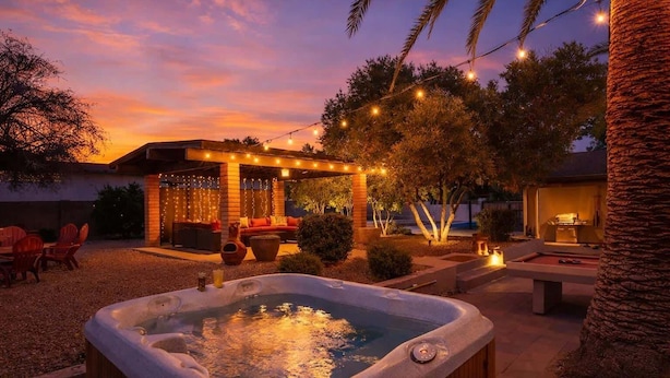 A hot tub, outdoor seating, string lights, and a pergola. - Sunset Palms-Pool, Spa & Sports Court-Scottsdale (Scottsdale)
