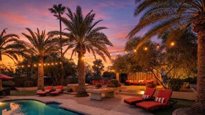 A pool area with lounge chairs, a fire pit, and string lights. - Sunset Palms-Pool, Spa & Sports Court-Scottsdale (Scottsdale)