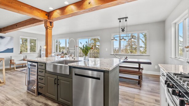 A modern kitchen with a large island, stainless steel appliances, and wooden beams. - Horseshoe Hideaway with Sunset Views (Jefferson)