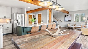 A modern kitchen with a large island, stainless steel appliances, and a rustic wooden ceiling. - Horseshoe Hideaway with Sunset Views (Jefferson)