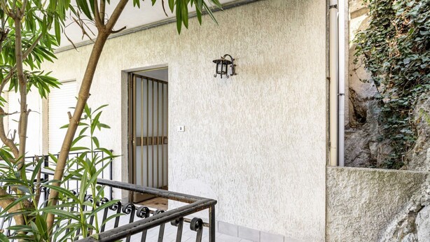 A balcony with a metal railing, a door, and a wall-mounted light fixture. - GuestHost - 68 sqm apartment for 2 people, featuring 3 balconies with a stunning sea view. Centrally located in Taormina, it offers the convenience of being close to all major attractions while remaining quiet and peaceful. Ideal for a couple seeking rel (Taormina)