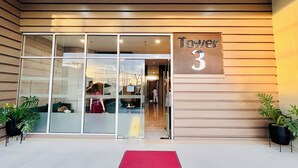 The entrance to a building with a sign reading "Tower 3".