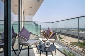 Relax on the balcony with a clear view of the surrounding landscape and highway.
