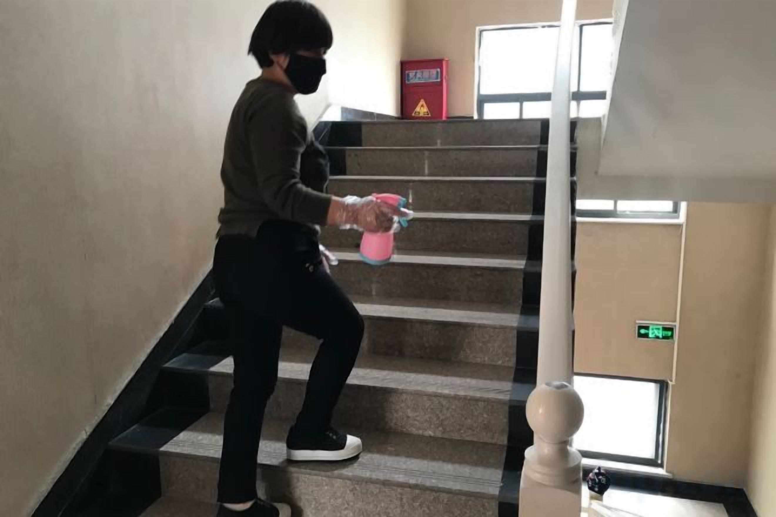 A person descending a staircase indoors.