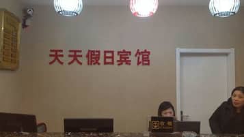 A reception desk with a sign reading "Cashier" and a wall with Chinese characters.