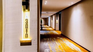 A hallway with a light fixture displaying the number 3010, a wooden floor, and a series of doors along the corridor. - Wuxi Fengshe Boutique Hotel (Jiangnan University Taihu Scenery Belt Store) (Wuxi)