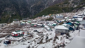 A snow-covered village with buildings and a mountainous backdrop. - Yangzom La Homestay  (Gangtok)