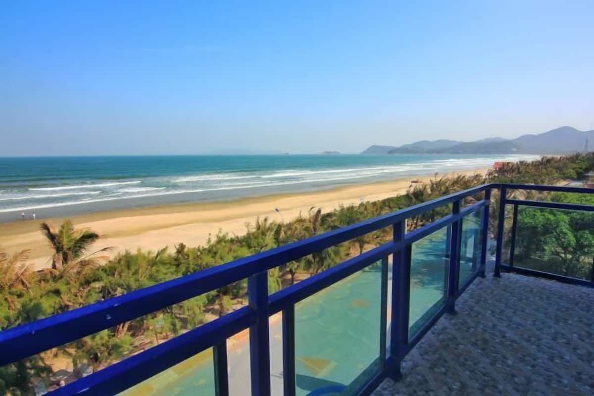 Un balcon offrant une vue dégagée sur la plage et l’océan.