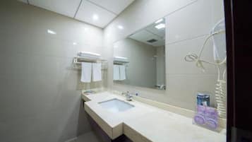A modern bathroom with a double sink, a large mirror, and a towel rack.