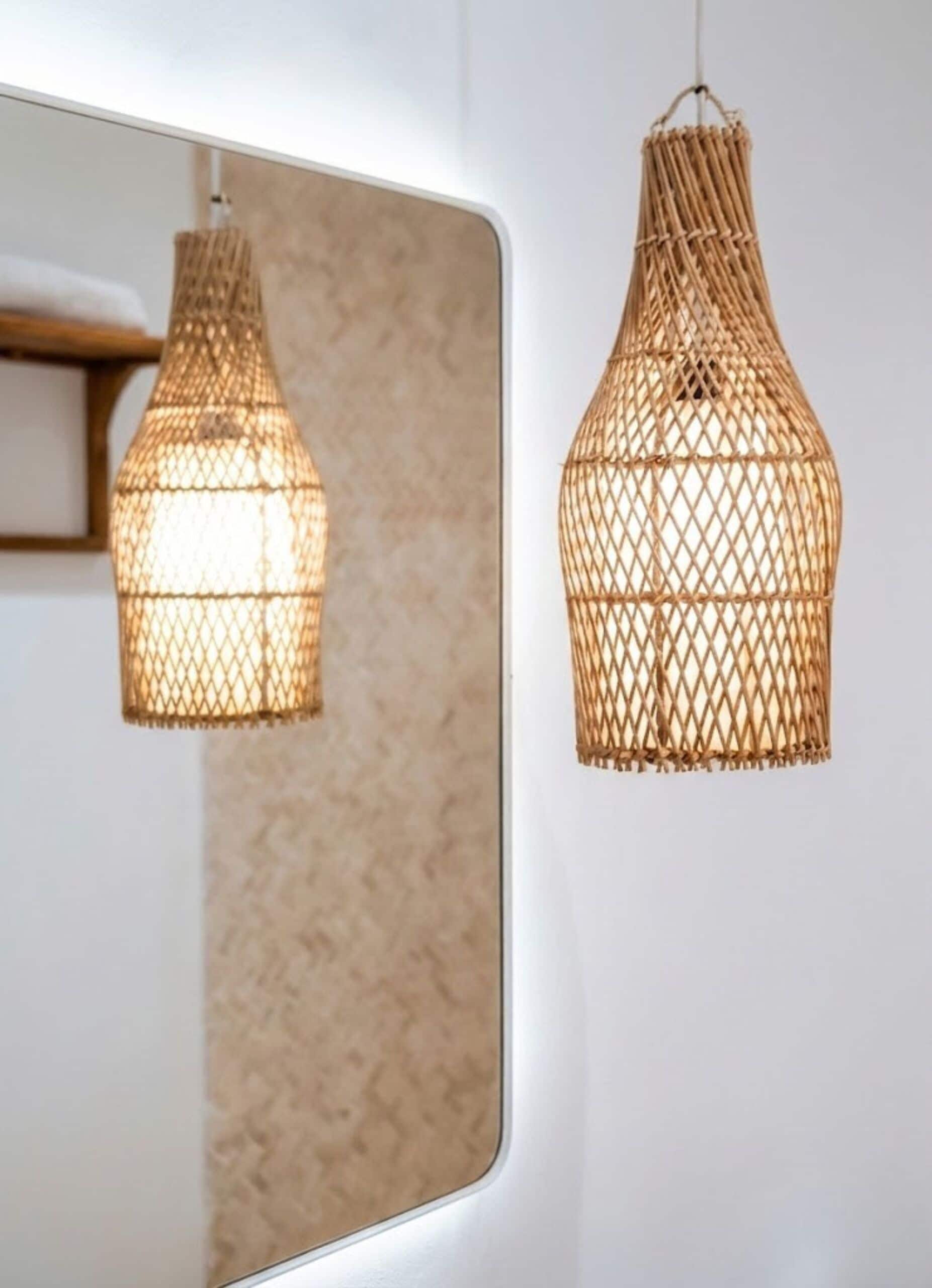 A mirror reflecting a woven pendant light fixture.