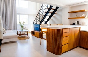 Apartment, 1 King Bed, Kitchen, Mezzanine | Living area | Books - Two Palms Bingin (Pecatu)