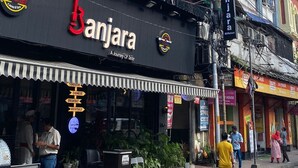 A building with a sign for 'Star City Hotel' and a restaurant named 'Banjara' with a sign indicating it offers Chinese breakfast and mocktails. - Hotel Star City (Kolkata)