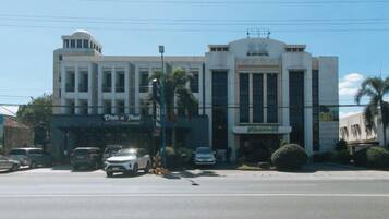 A multi-story building with a prominent entrance and signage for a business.
