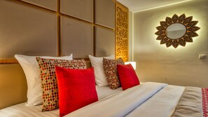 A hotel room with a bed, pillows, a wall-mounted mirror, and a decorative panel. - Azalai Hôtel Dakar (Dakar)