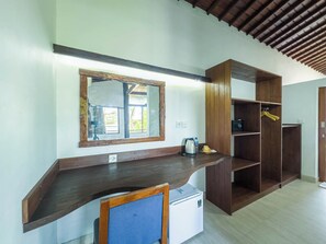 Cozy retreat with storage, compact seating area, and a small refrigerator.