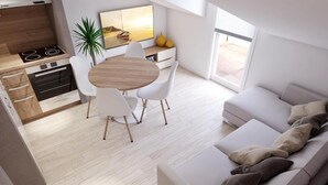 Een moderne keuken met een eethoek, een bank en een groot raam.
