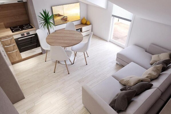 Eine moderne Küche mit Essbereich, einer Couch und einem großen Fenster.
