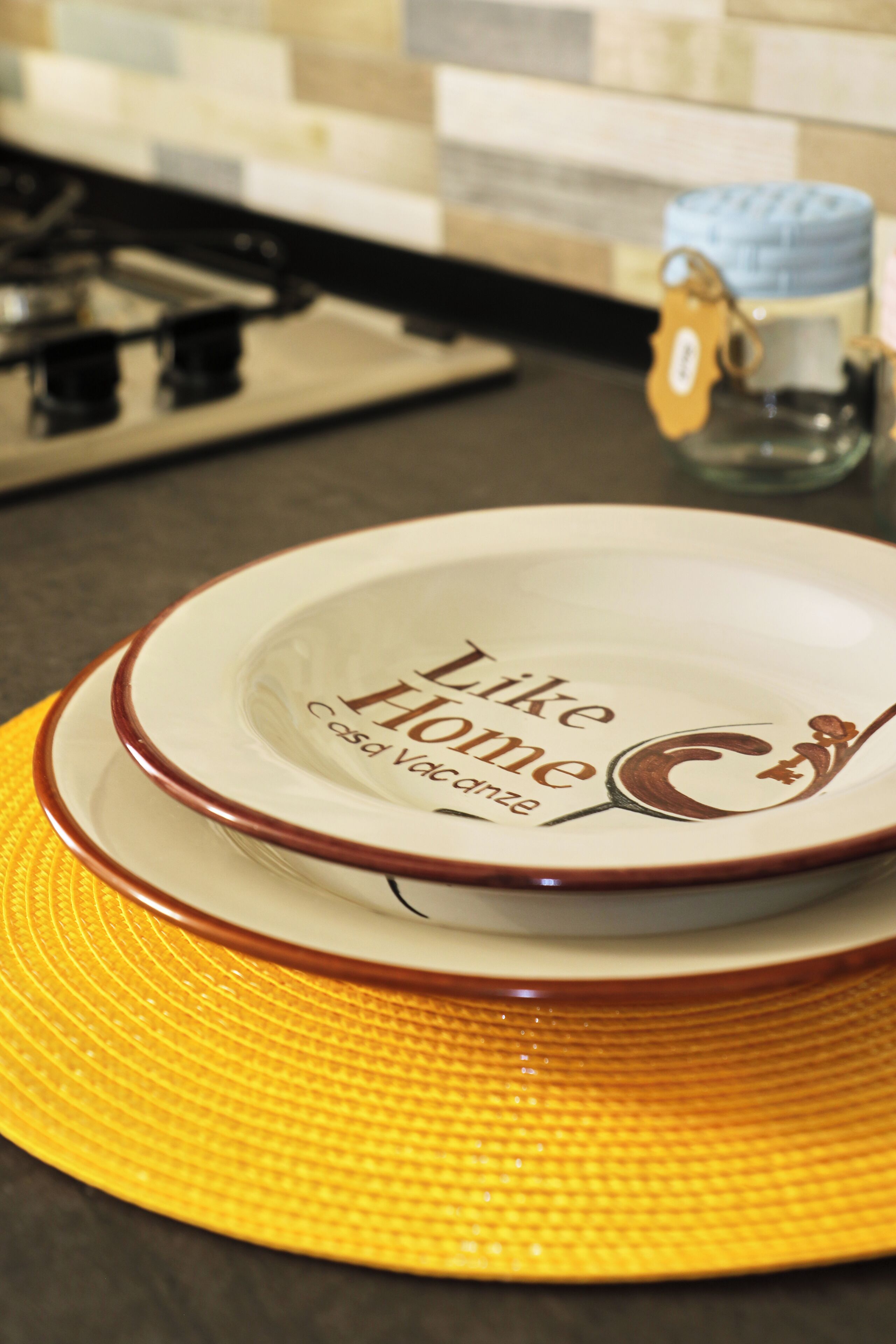 Un comptoir de cuisine sur lequel est posée une assiette portant l’inscription « Like Home Casa Valencia ».