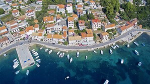An aerial view of a coastal village with houses, a marina, and boats. - Apartment Dominik - Two Bedroom Apartment with Terrace and Sea View (Smokvica)