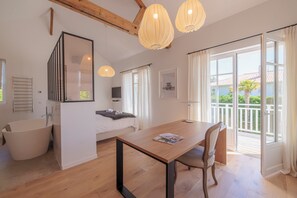 Enjoy a comfortable stay in this stylish room featuring a large bed, TV, and a dining table.