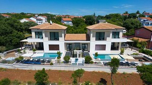 A modern two-story house with a swimming pool and outdoor seating. - Villa Lord With Heated Pool Jacuzzi and Sauna (Krk)