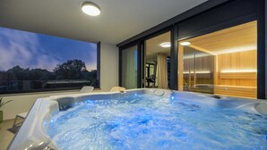 A hot tub with a view of the sky and trees, a wooden wall, and a glass door leading to a room. - Villa LEA Magdalena III (Krk)