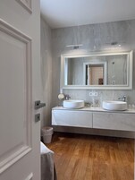 Luxury Suite, Balcony, City View | Bathroom | Hair dryer, bathrobes, slippers, towels