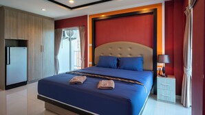 A modern hotel room with a large bed, a wardrobe, a nightstand, and a window with curtains. - New Nordic VIP 6 Kristine (Pattaya)