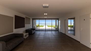 A spacious living area with a large sliding glass door leading to an outdoor patio.