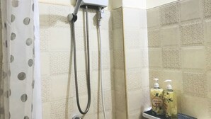 A shower with a handheld showerhead and a wall-mounted control panel. There are two bottles of hand soap on a shelf. - Cozy 1-bedroom with WiFi and AC in delightful Chiang Mai, Self-check-in, Parking (Chang Wat Chiang Mai)
