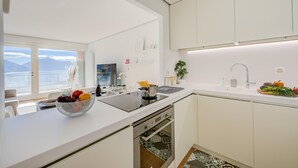 A modern kitchen with a large window, a built-in stove, and a dishwasher.