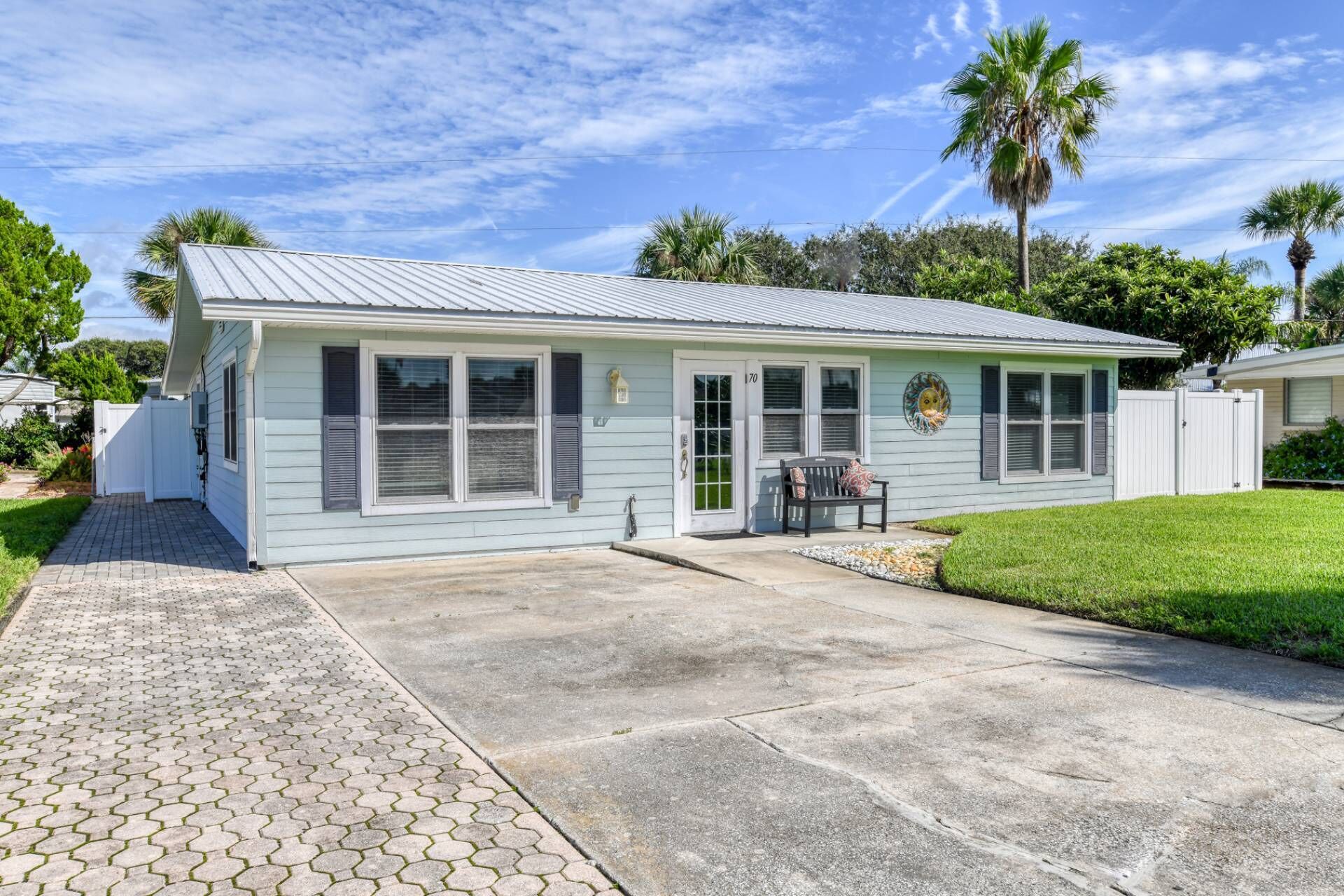 A single-story house with a covered patio, a front door, and a mailbox.