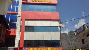 A multi-story building with a prominent sign for Hotel Grand Kailash. - Hotel Grand Kailash (Joshimath)