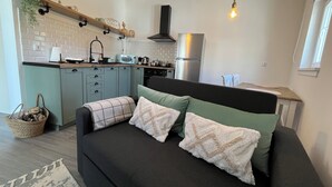 A modern kitchen with a built-in oven, microwave, and stainless steel refrigerator. - Casa da Calabra by Trip2Portugal (Vila Nova de Foz Coa)