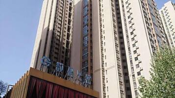 A high-rise building with a prominent sign at the top.