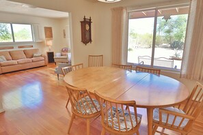 Relax in this spacious living room with a large dining table and comfortable seating for six.
