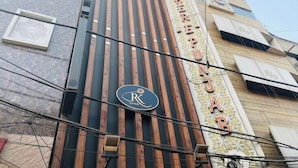 A hotel facade with vertical wooden slats, a prominent 'R' logo, and the name 'Sahera' in decorative script. - Hotel RK Grande (Ludhiana)