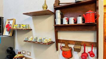 Full-sized fridge, microwave, cookware/dishes/utensils, paper towels