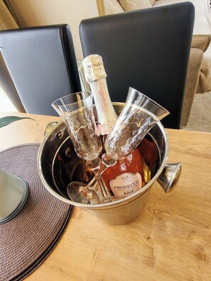 A metal bucket containing a bottle of Prosecco wine and several wine glasses. - The Westwood at Percy Wood (Morpeth)