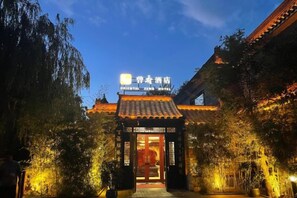 A traditional building with a sign for the Oriental Zen Hotel. - Oriental Zeng Hotel (Beijing)