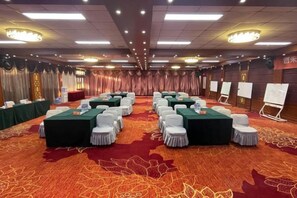 A conference room with round tables, white chairs, and a carpeted floor. - Oriental Zeng Hotel (Beijing)