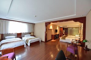 A hotel room with two beds, a desk, a chair, and a television. - Oriental Zeng Hotel (Beijing)