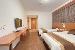 A hotel room with two beds, a desk, a TV, and a patterned headboard. - Jinyuan Motel (Yueqing)