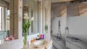 A bathroom with a marble sink, a large mirror, and a shower area. - The Inn at the Spanish Steps Exclusive Collection - Condotti Luxury Suites (Rome)