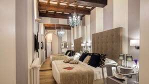 A bedroom with two beds, a chandelier, bedside lamps, and a desk with a cup. - The Inn at the Spanish Steps Prestige Collection - The Pearl (Rome)