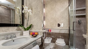 A modern bathroom with a marble sink, a glass shower enclosure, a bidet, and a toilet. - The Inn at the Spanish Steps Luxury Collection - Mario de' Fiori Home (Rome)