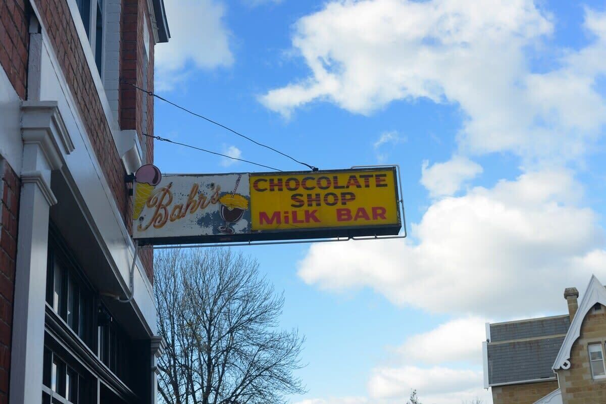 A sign for a chocolate shop and milk bar.